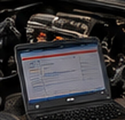 Diagnostic laptop connected to the Jeep's engine