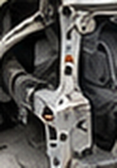 Close-up of the bent radiator support behind the Camry's bumper