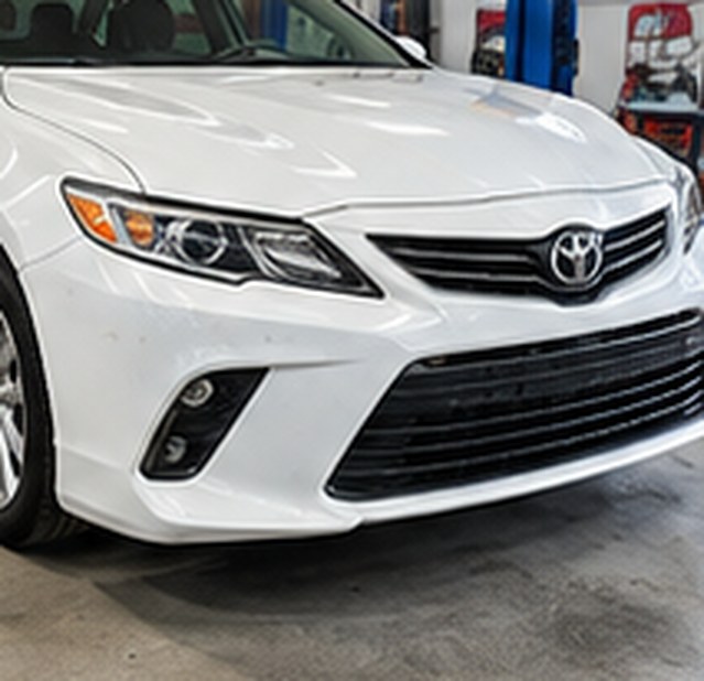 White Toyota Camry front end after repair, with new bumper and headlight