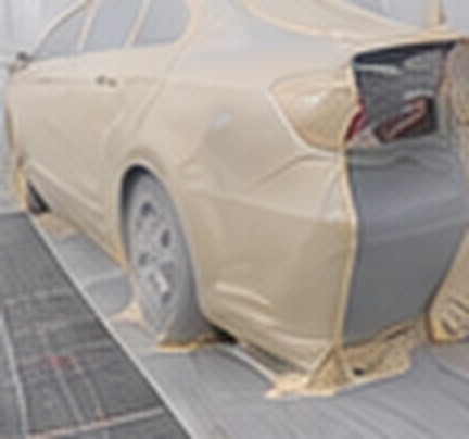 Toyota Camry masked for painting in the paint booth
