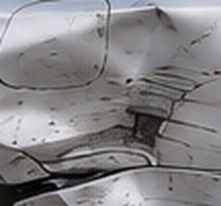 Close-up of the creased metal on the Honda Accord's rear quarter panel